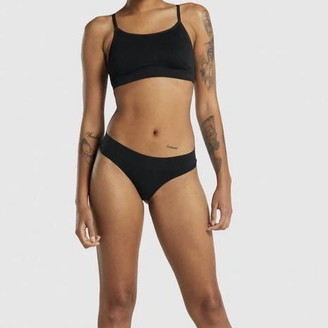 Person wearing a black bikini on a white background