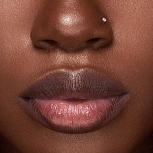 Close-up of a person's lips with a focus on the lipstick color.