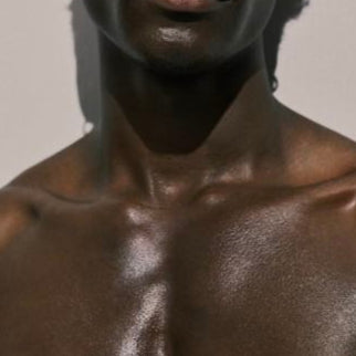 Man with a textured skin tone against a neutral background