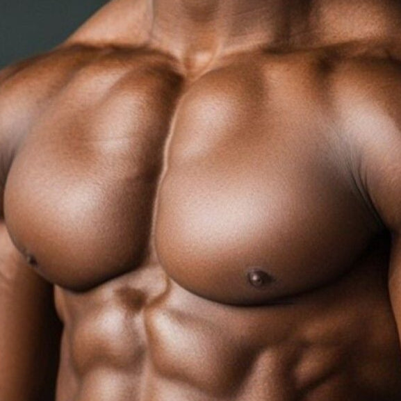 Muscular man with a fit physique wearing white shorts indoors.