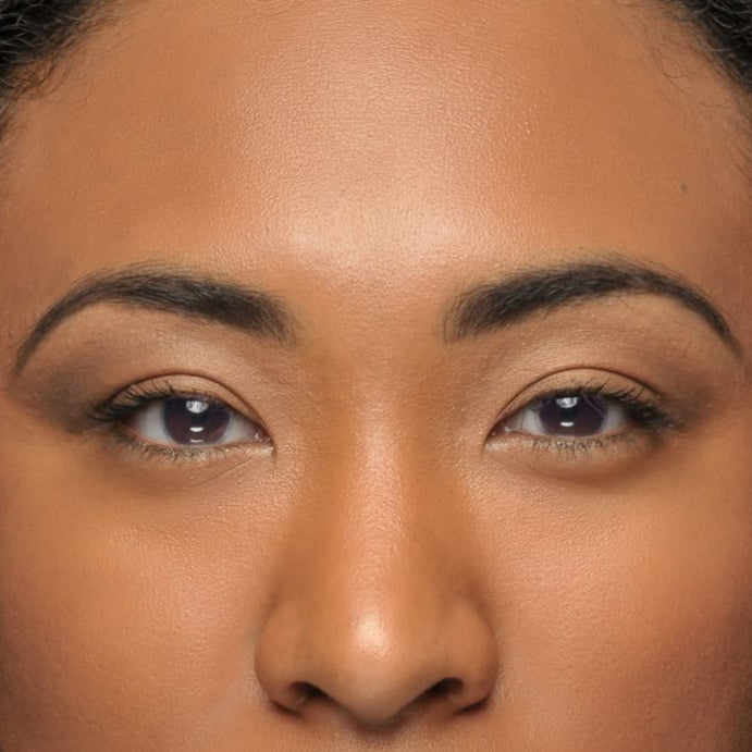 Close-up of a person with shoulder-length hair against a neutral background