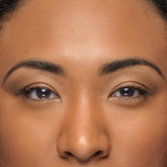 Close-up of a person with shoulder-length hair against a neutral background