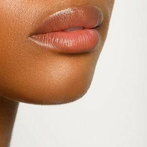 Woman with a short haircut against a plain background