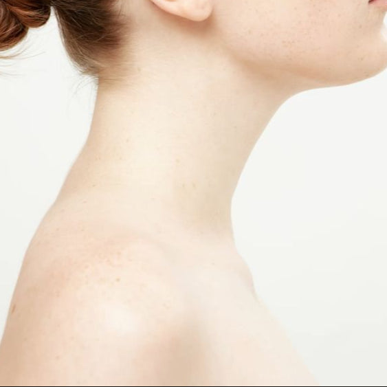 Woman with a bun hairstyle on a plain background