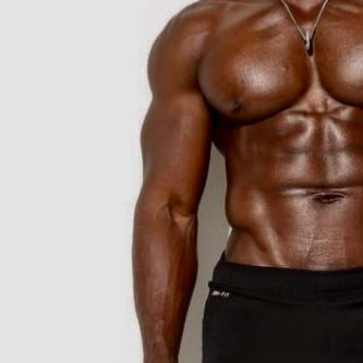 Muscular person wearing black shorts and white sneakers against a white background