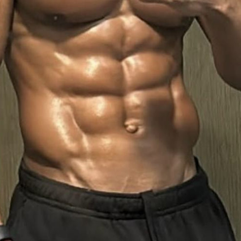 Man taking a mirror selfie showing off his muscular physique against a neutral background