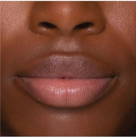 Close-up of a person's lips with a neutral background